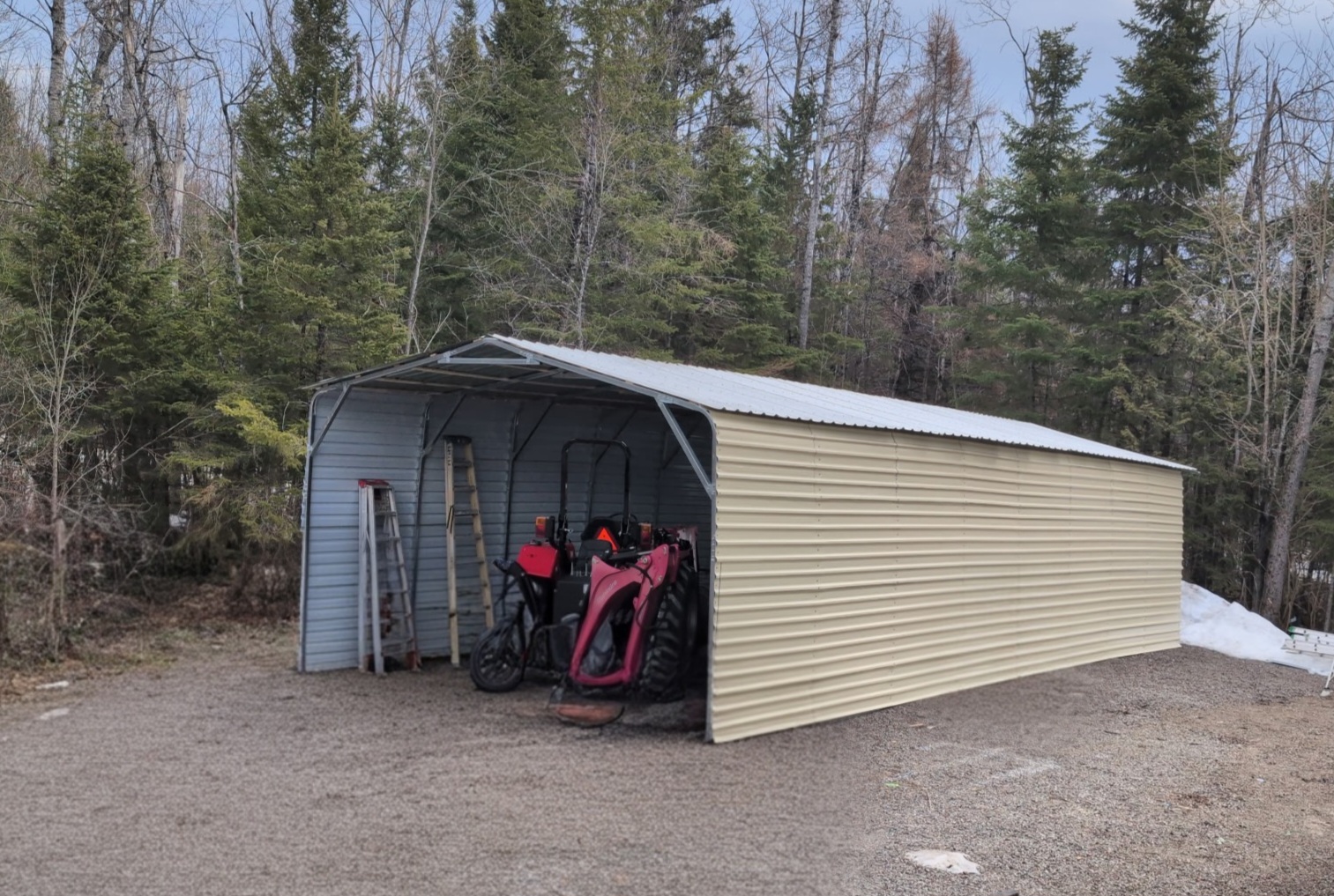 Exterior side view of a detached metal carport and shelter structure.