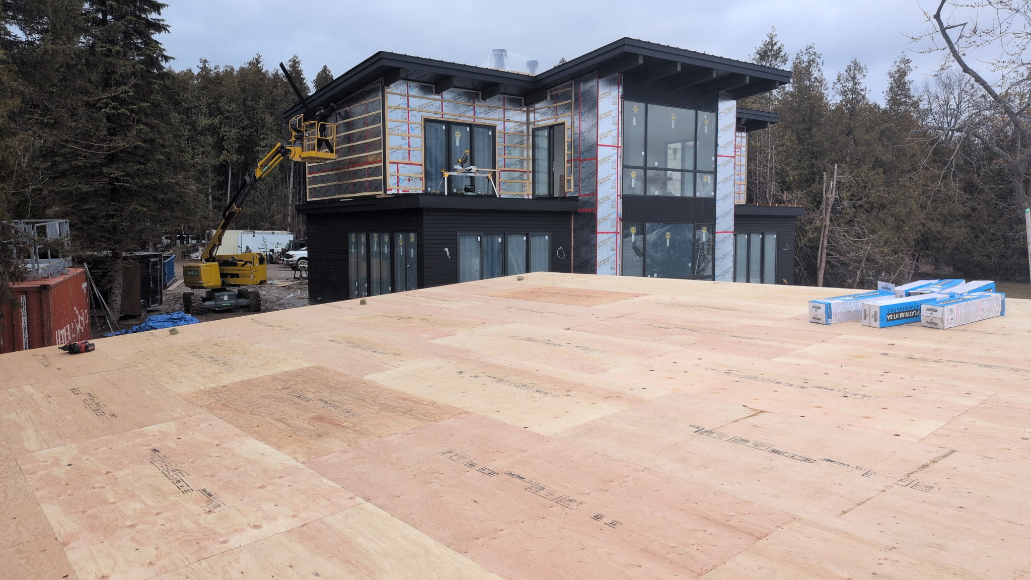 Lower roof deck view with the lakefront modern home in the background.