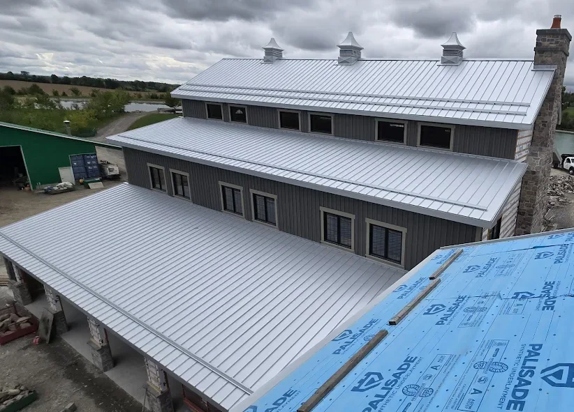 Elevated view of silver steel roofing across a large building.